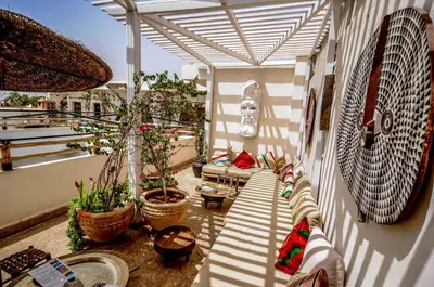 a balcony with chairs and potted plants on a building at Riad Villa Almeria Hotel & Spa in Marrakech