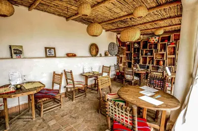 a restaurant with tables and chairs in a room at Riad Villa Almeria Hotel & Spa in Marrakech