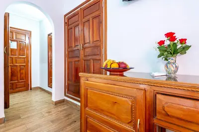 a room with a wooden cabinet with a bowl of fruit on it at Hotel Oudaya & Spa in Marrakech