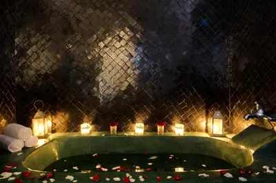 a pool with candles and lights in a room at Riad Vert in Marrakech