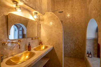 a bathroom with two sinks and a mirror at Riad Nora in Marrakech