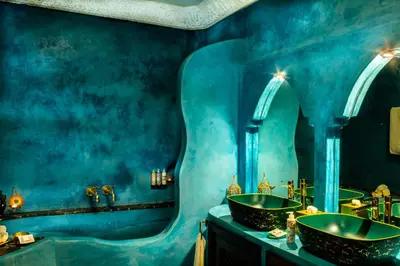 a blue bathroom with a sink and a mirror at Maïpa Boutique Riad in Marrakech