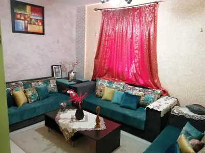 a living room with two couches and a pink curtain at Relaxation apartment in Marrakech