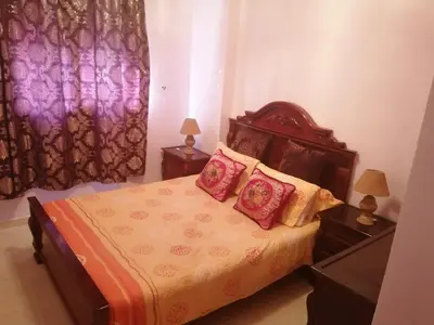 a bedroom with a bed with pillows and a window at Relaxation apartment in Marrakech