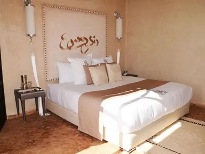 a bedroom with a large bed in a room at Palais Lona in Marrakech