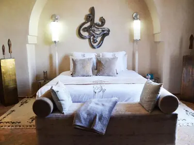 a large bedroom with a large bed with pillows at Palais Lona in Marrakech