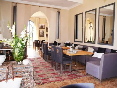 a dining room with a table and chairs at Palais Lona in Marrakech