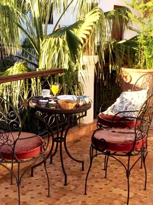 a table and two chairs and a table and chairs at Riad Fatinat Marrakech in Marrakech