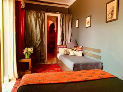 a room with two beds in a room with a window at Dar Zemrane in Marrakech