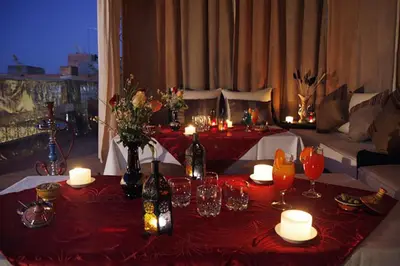 a living room with a table with candles and wine bottles at Riad Shaloma in Marrakech