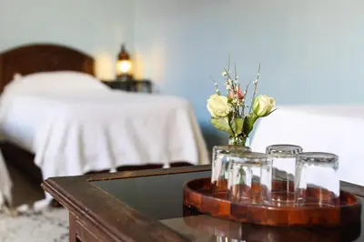 a table with a vase of flowers on top of it at Riad Marhbabikoum in Marrakech