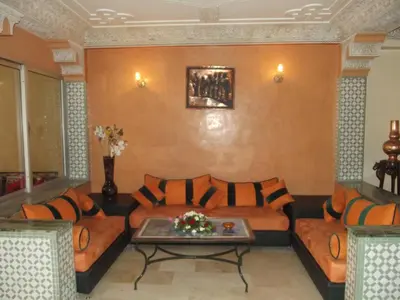 a living room with couches and a table at Hotel Al Kabir in Marrakech