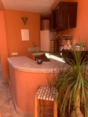 a kitchen with an island in the middle of a room at Riad Abaka hotel & boutique in Marrakech