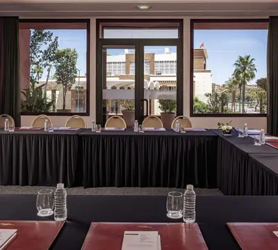 a long black table with wine glasses in a restaurant at Grand Plaza Marrakech in Marrakech