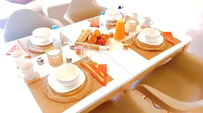 a white table with a tray of food on it at Marrakech golf city prestigia in Marrakech