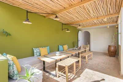 a living room with a couch and a table and chairs at Riad Helen in Marrakech