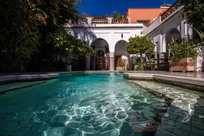 a swimming pool in the courtyard of a house at Palais Dar Donab in Marrakech