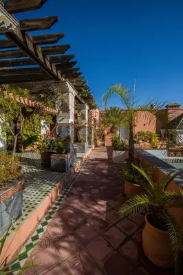 a patio with potted plants and a roof at Palais Dar Donab in Marrakech