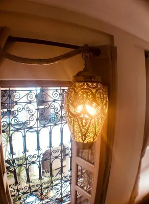 a chandelier hanging in front of a window at Riad Bamboo Suites & Spa in Marrakech