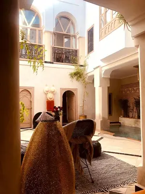 a living room with a large building with windows at Riad Bamboo Suites & Spa in Marrakech