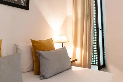 a bedroom with a bed with pillows and a window at Riad Alia in Marrakech