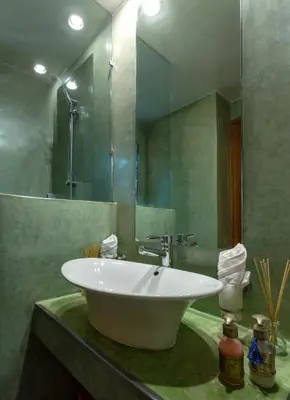 a bathroom with a white sink and a mirror at Riad l'Heure d'Eté in Marrakech