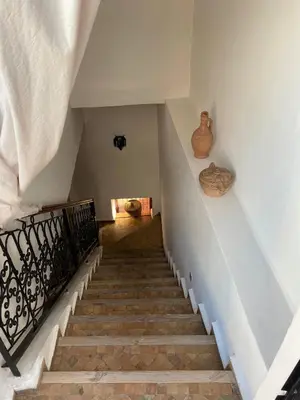 a staircase with vases on the wall and a stair case at Les Jardins Mandaline in Marrakech