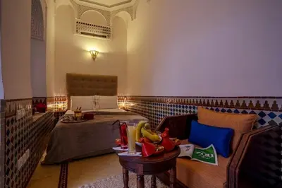 a living room with a couch and a bed at Riad Safran et Cannelle & Spa in Marrakech