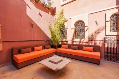 an orange couch sitting on the side of a building at Riad Ushuaia - Centre Marrakech in Marrakech