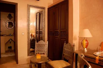 a room with a desk and a mirror and a table at Riad D'Airain in Marrakech