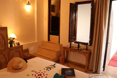 a living room with a bed and a window at Riad Chergui in Marrakech