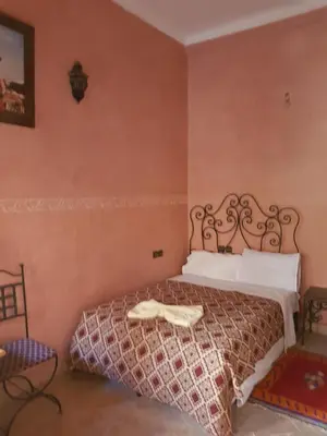 a bedroom with a bed in a room at Hotel Wissam in Marrakech