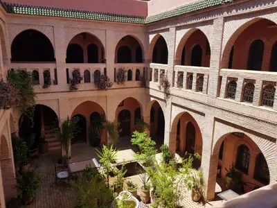 an image of a building with a courtyard with plants at Hotel Wissam in Marrakech