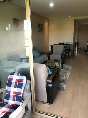 a living room with a couch and a table at APPARTEMENT Golf Marrakech prestigia in Marrakech