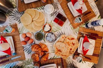 a table topped with lots of different types of food at Riad Manaoui in Marrakech