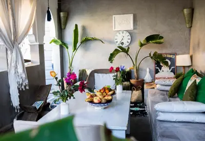 a living room with a table with fruits and plants at Riad les 2 Portes in Marrakech