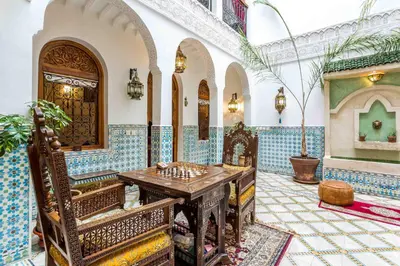 a room with a table in a building with tiles at Riad Mouna in Marrakech