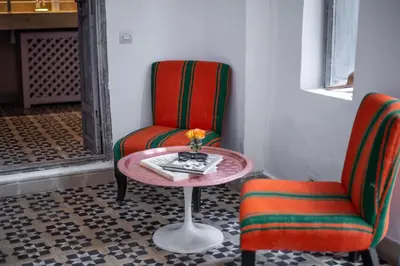 a table and two chairs in a room at Riad Dar Tmania in Marrakech