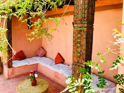 a bed in the side of a building at Riad AKL in Marrakech