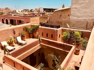 a view of a building with potted plants on it at Riad AKL in Marrakech