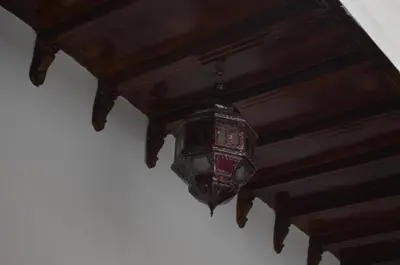 a chandelier hanging from a wooden ceiling at Mosaic Hostel in Marrakech