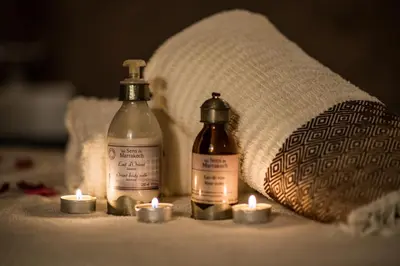 a group of candles and bottles on a bed at Riad Dar Elma And Spa in Marrakech