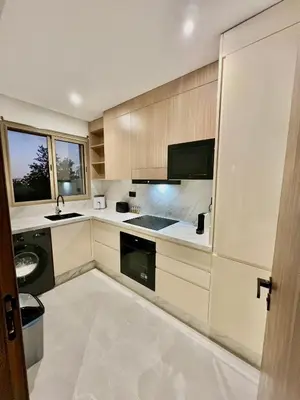 a kitchen with a sink and a stove top oven at Marrakech golf City prestigia in Marrakech