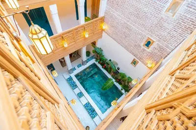 an overhead view of a swimming pool in a building at Riad Tibibt in Marrakech
