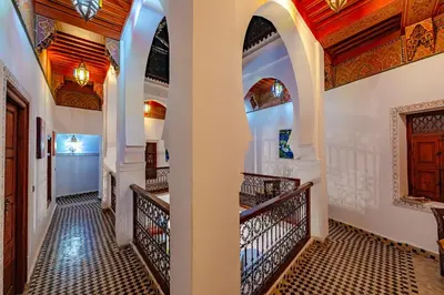a hallway of a house with arches and a staircase at Maison Do in Marrakech