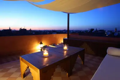 a table with candles on top of a roof at Riad CHERRATA in Marrakech