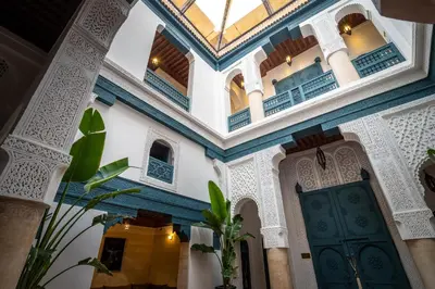 a building with a blue and white ceiling and a door at Dar Alhambra Riad Medina in Marrakech