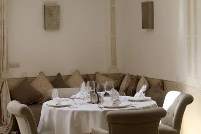 a dining room with a table with wine glasses at Medina Dream Riad Exclusive Rental in Marrakech