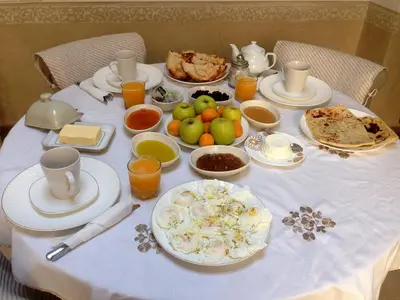 a table with breakfast foods and drinks on it at Medina Dream Riad Exclusive Rental in Marrakech
