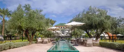 a row of tables and chairs with umbrellas at Selman Marrakech in Marrakech